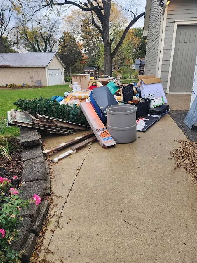 Dumpster being loaded with debris for 12 Yard Dumpster Rental in Grand Bay